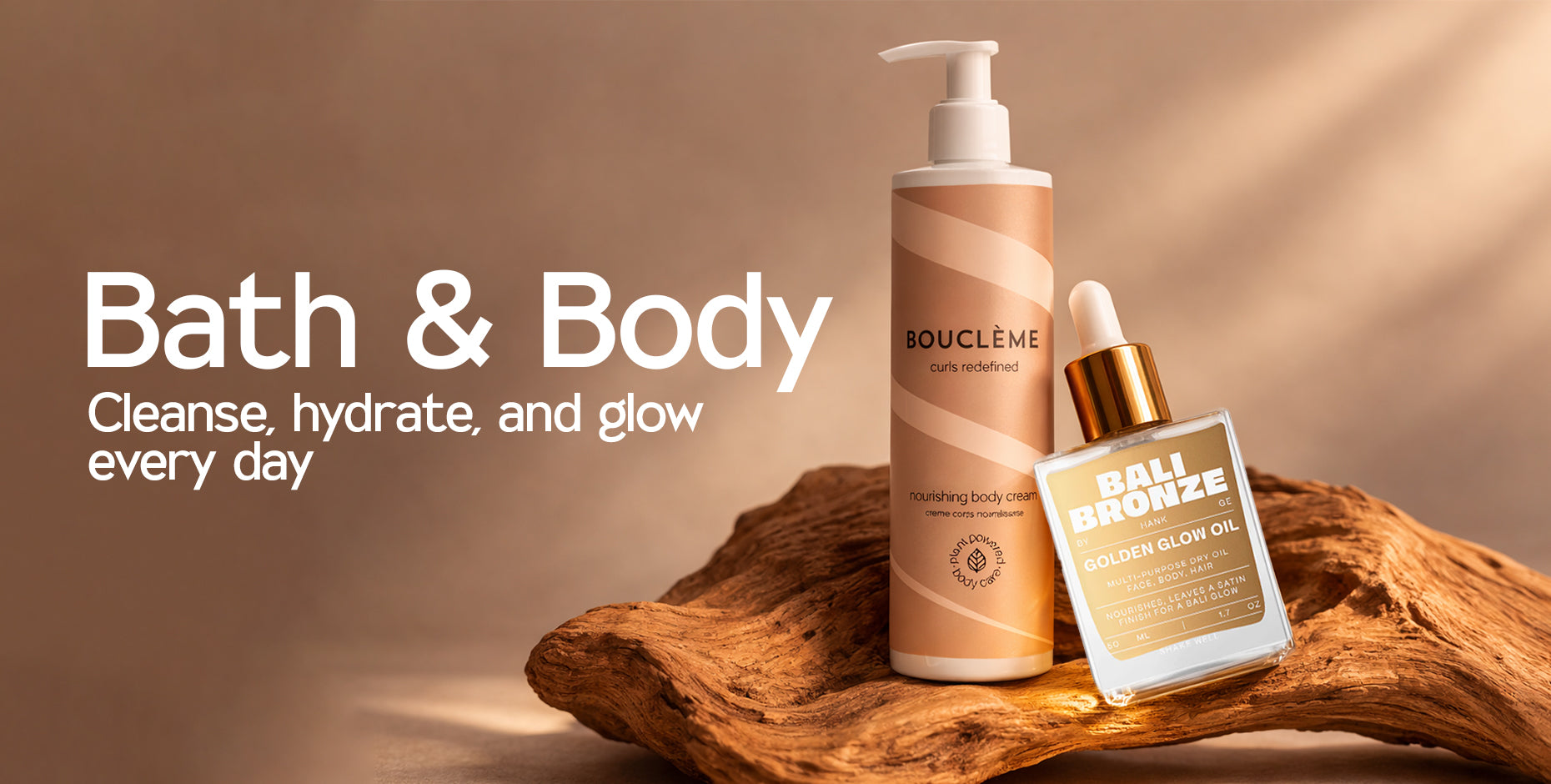 Nourishing body cream and golden glow oil on natural wood, promoting daily cleanse, hydrate, and glow.