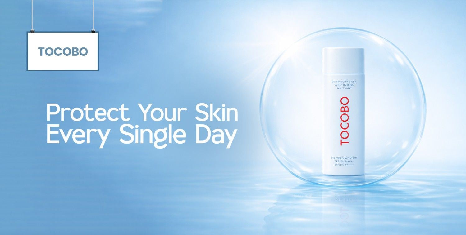 Tocobo skincare collection featuring a white sunscreen bottle in a clear bubble on a serene blue background.
