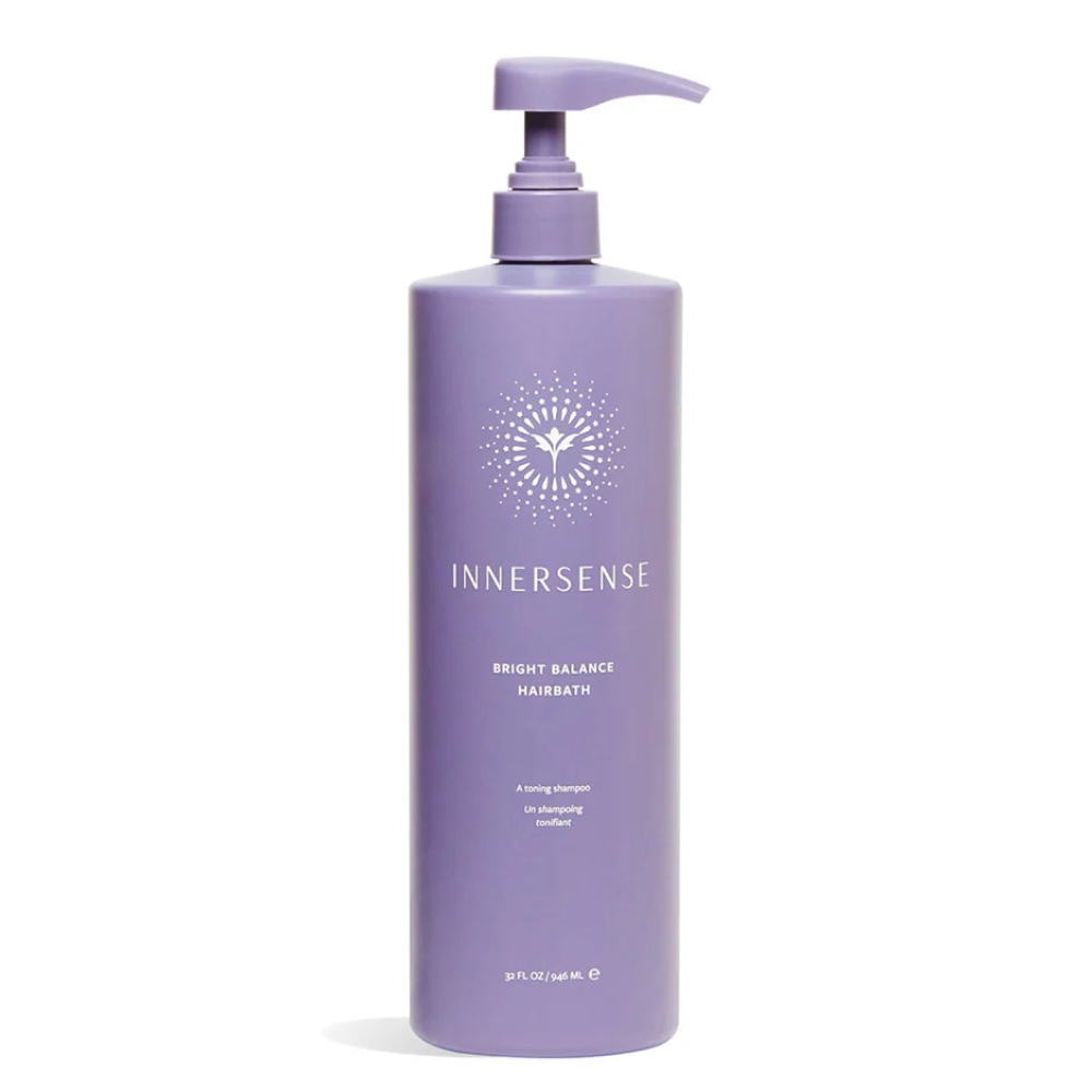 Large purple Innersense Bright Balance Hairbath pump bottle with white logo and text.