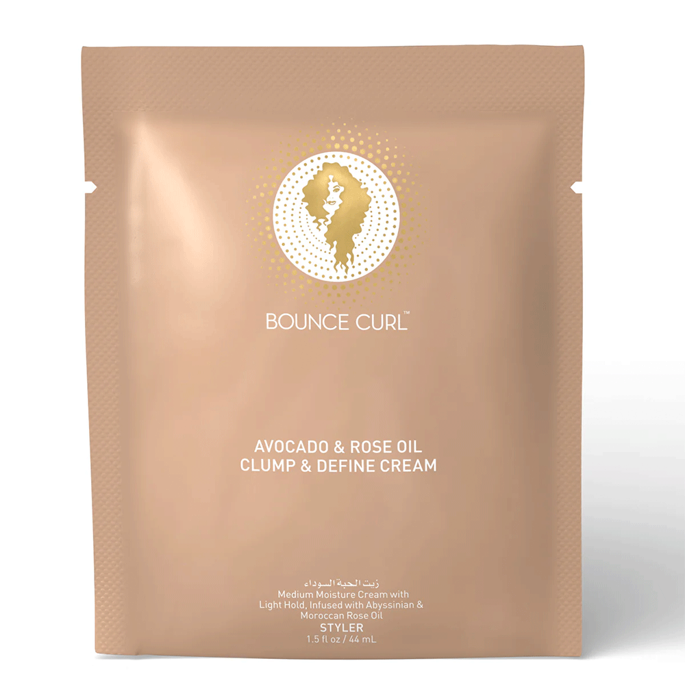 Bounce Curl Avocado & Rose Oil Clump & Define Cream in a peach-colored pouch with gold logo and text.