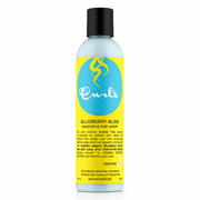 Light blue Curls Blueberry Bliss Reparative Hair Wash bottle with black cap and yellow/blue label.
