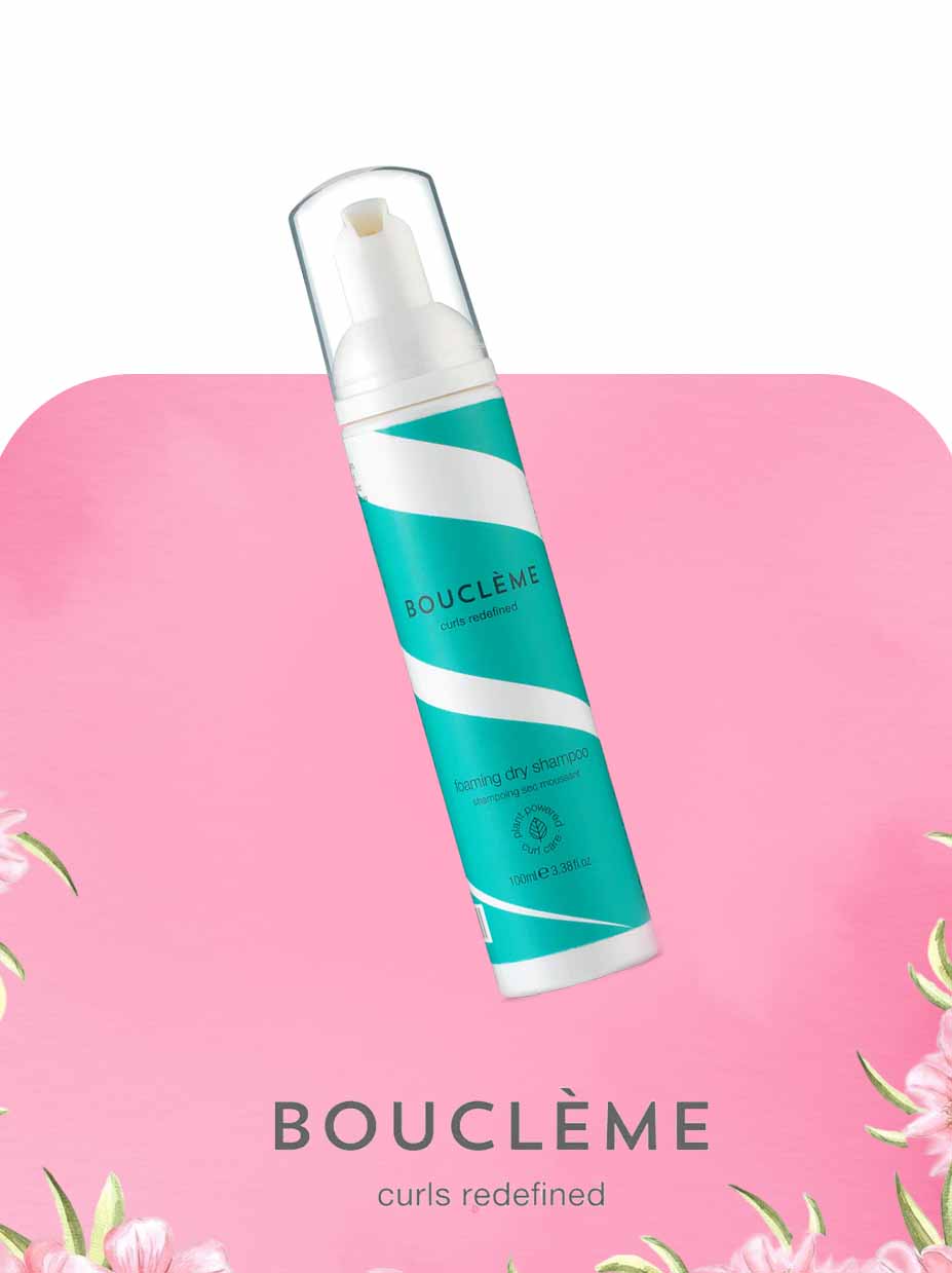 Boucleème hair product bottle on a pink background 